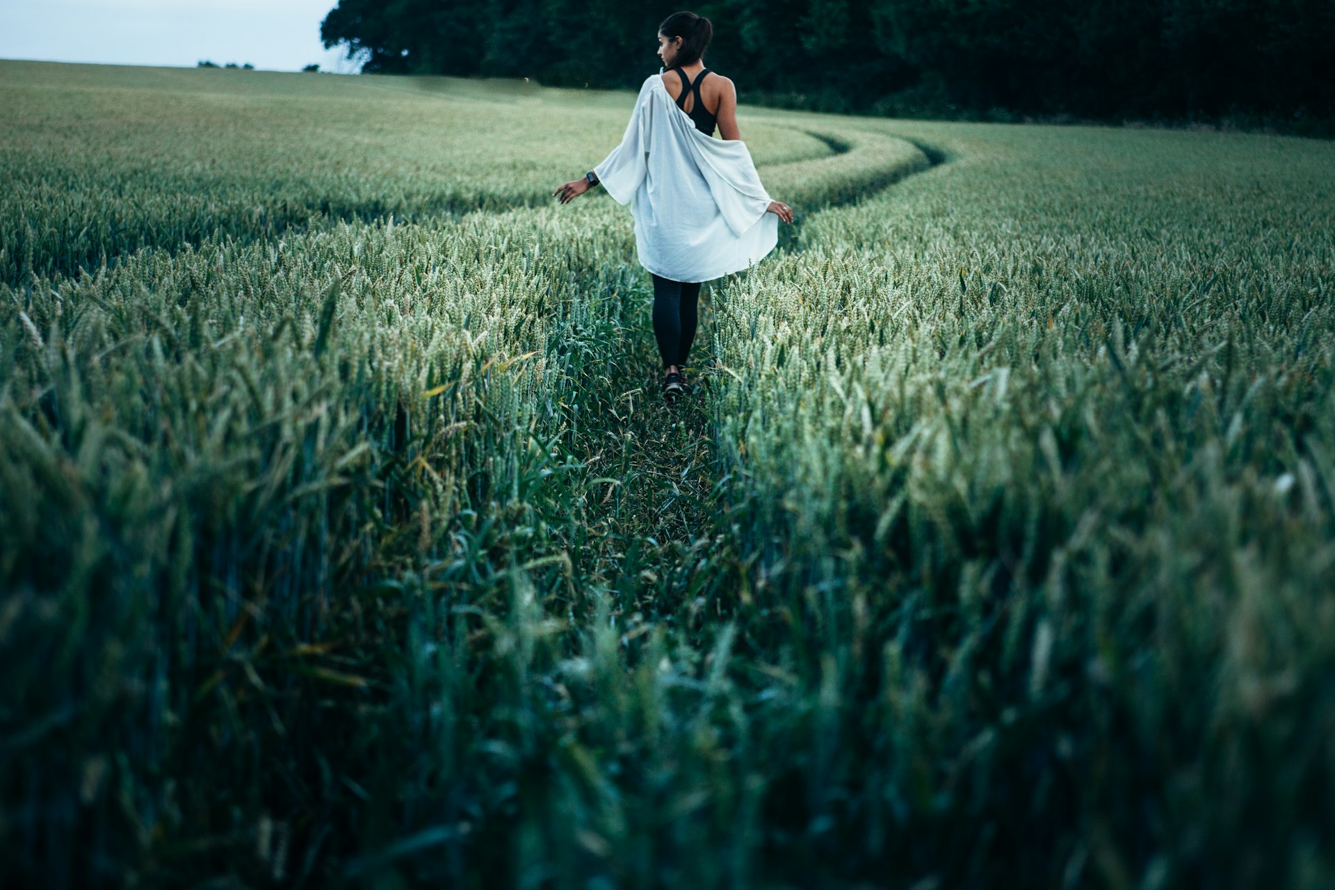 woman walking on grass field